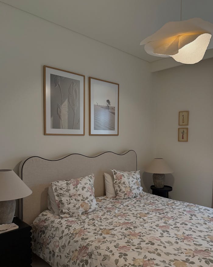 Elegant bedroom interior with floral bedding and modern artwork. Perfect for home inspiration.